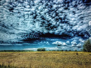 Scenic view of landscape against cloudy sky