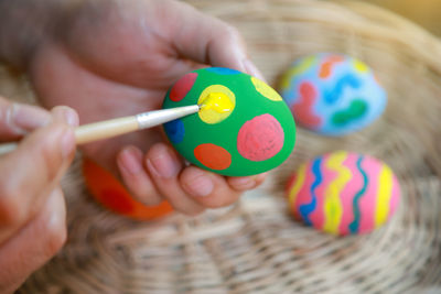Close-up of baby hand holding multi colored candies