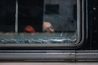 Portrait of woman seen through car window