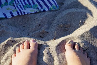 Low section of legs on sand