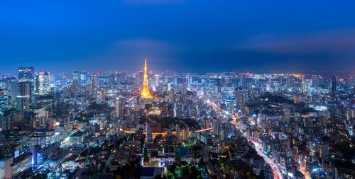 Aerial view of city lit up at night