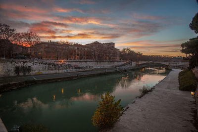 Scenic view of river against sky at sunset