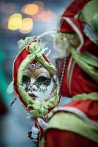 Close-up of woman wearing mask and costume during carnival