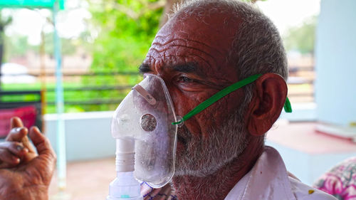 Close-up of man wearing nebulizer