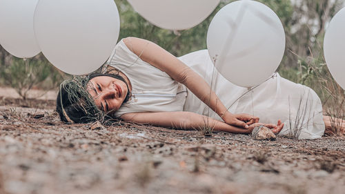 Midsection of woman lying down on land