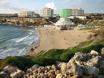 Panoramic view of beach and buildings against sky