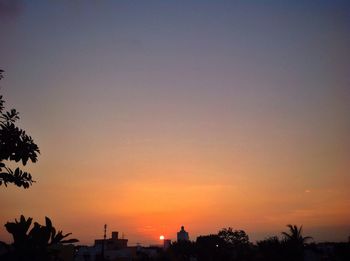 Silhouette trees against sky during sunset
