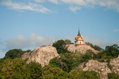 Temple by building against sky