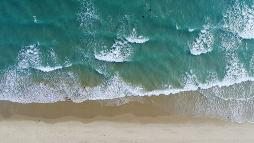 High angle view of waves rushing towards shore