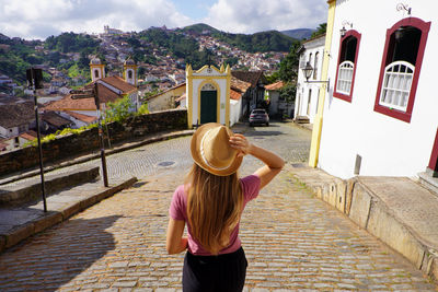 Rear view of woman standing in city