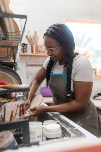 Woman washing her pottery at the ceramics studio