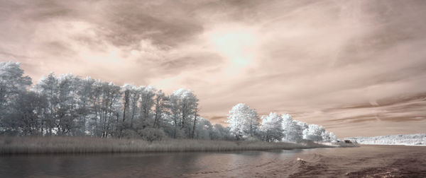 Scenic view of lake against sky during winter