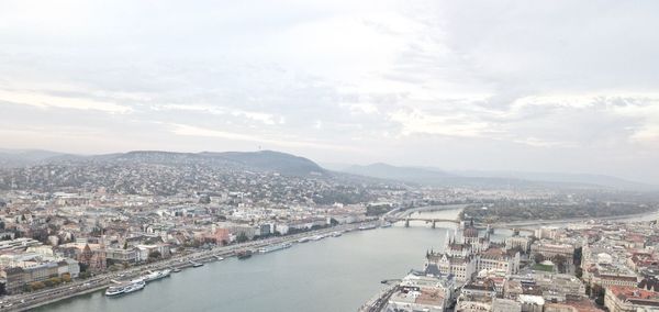 High angle view of townscape by river against sky