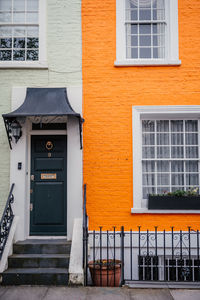 Vibrant orange and mint green urban house facades