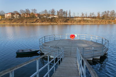 Pier over lake against sky