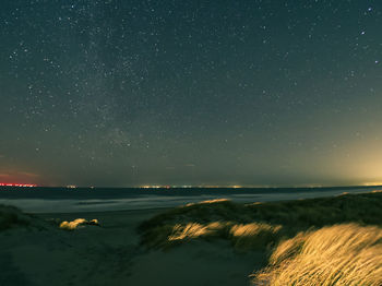 Scenic view of sea against sky at night