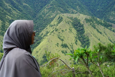 Rear view of woman standing on mountain