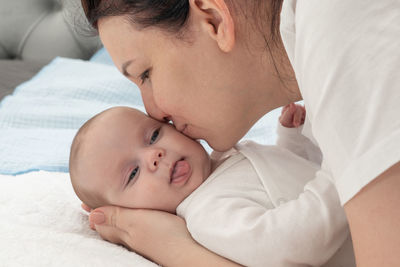 Side view of boy sleeping on bed at home