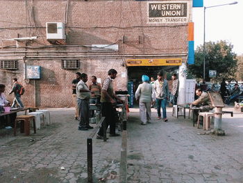 People on sidewalk in city