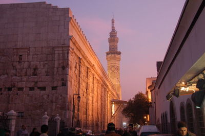 View of illuminated buildings against sky in city