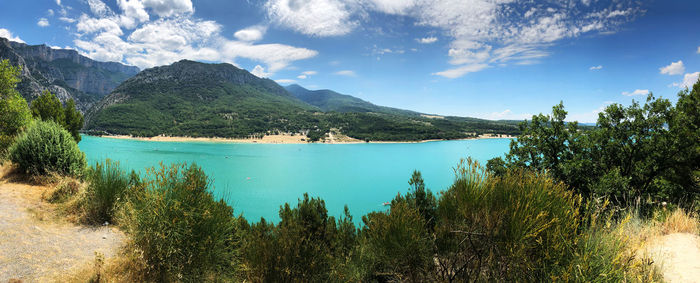 Scenic view of sea and mountains against sky