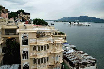 High angle view of townscape by sea against sky