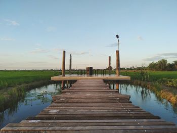 Pier over lake against sky