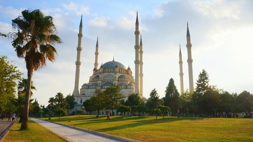 View of mosque against cloudy sky