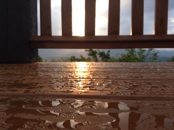 Close-up of wet illuminated walkway in rainy season