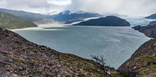 Scenic view of sea and mountains against sky