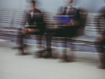 Blurred motion of people walking on street in city