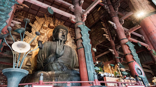 Low angle view of statue against building