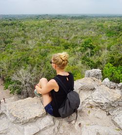 Woman sitting on rock