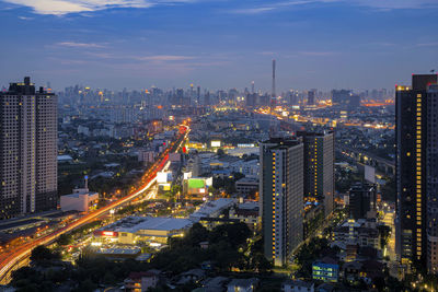 High angle view of illuminated buildings in city against sky