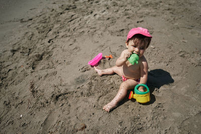 Girl playing with toy on beach