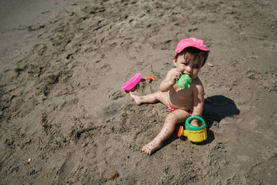 A baby playing with beach toys in the sand. vacation concept