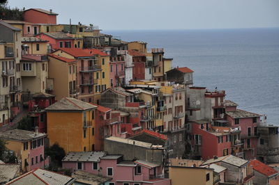 High angle view of townscape by sea against sky