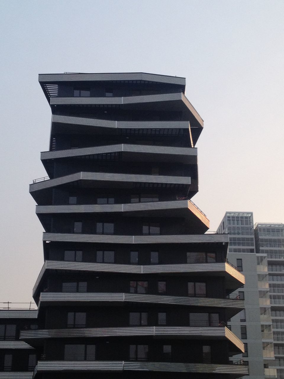 building exterior, architecture, built structure, low angle view, modern, office building, building, city, skyscraper, tall - high, tower, window, clear sky, glass - material, day, reflection, sky, outdoors, tall, residential building