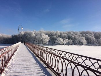 Snow covered footpath against sky