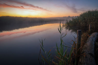 Scenic view of lake against sky during sunset