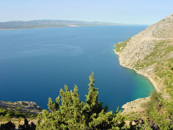 High angle view of sea and mountains against sky