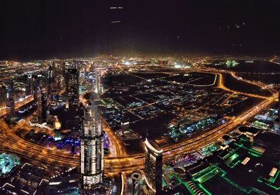 High angle view of city lit up at night