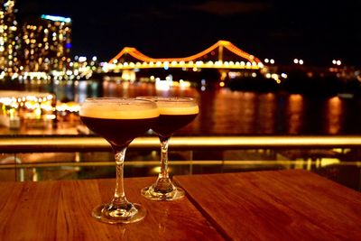 Close-up of wine glasses at night