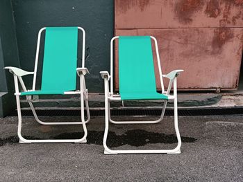 Empty chairs against wall