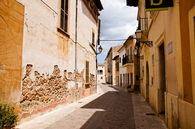 Narrow alley amidst buildings in town