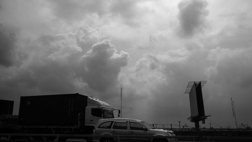 Factory against cloudy sky