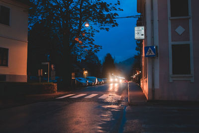 Illuminated city street at night