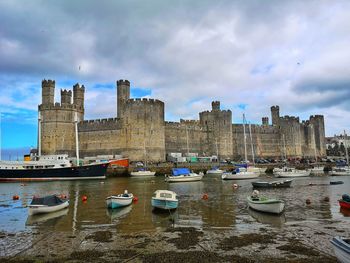 Caernarfon castle viewed across a river. caernarfon. gwynedd. wales.uk