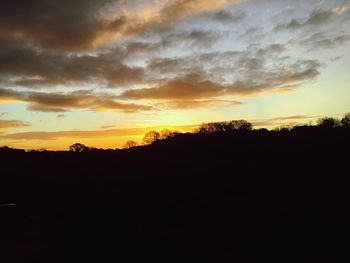 Silhouette landscape against sky during sunset