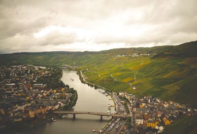 High angle view of river amidst cityscape against sky